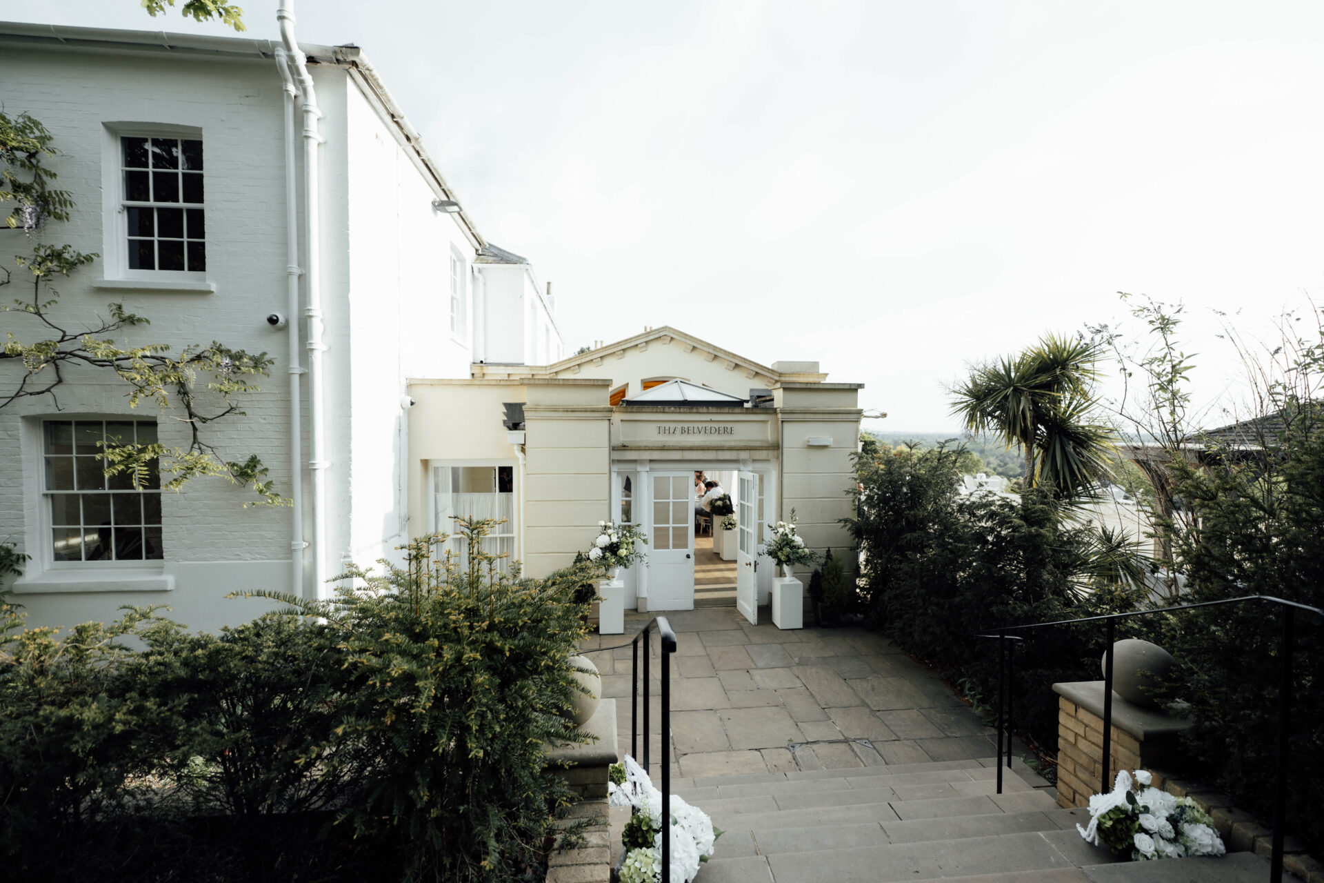 The Belvedere entrance with one white door propped open.