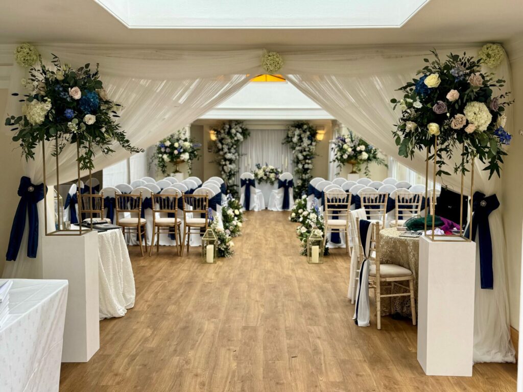 An ornately decorated room with floral arrangements.