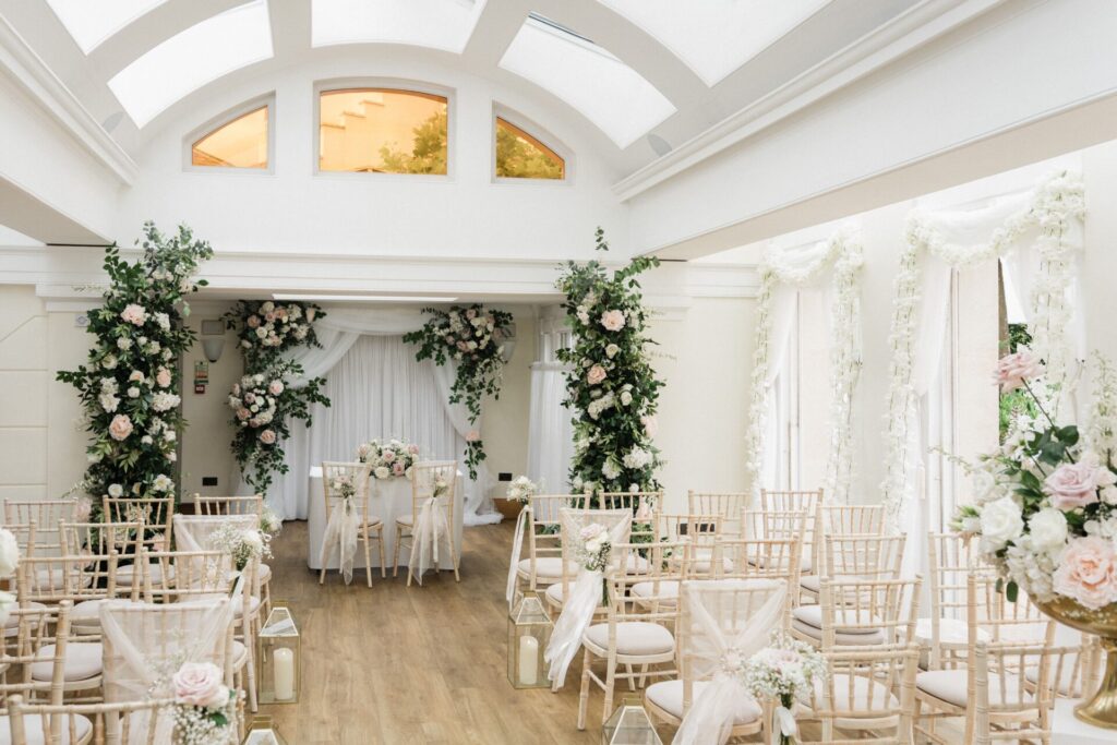 A bright, large room with decorate rows of chairs.